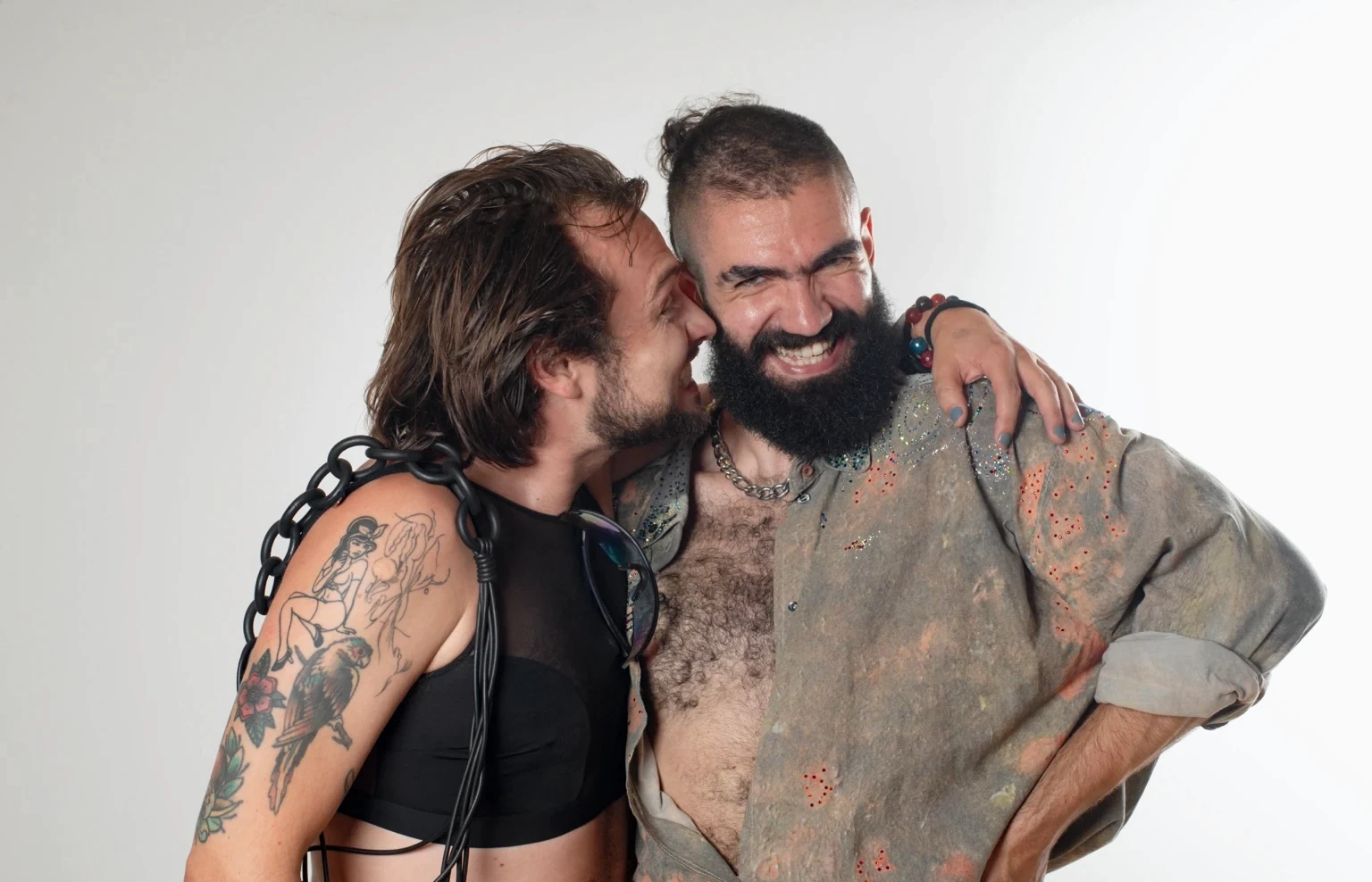 Two people laugh together in a close, affectionate portrait.