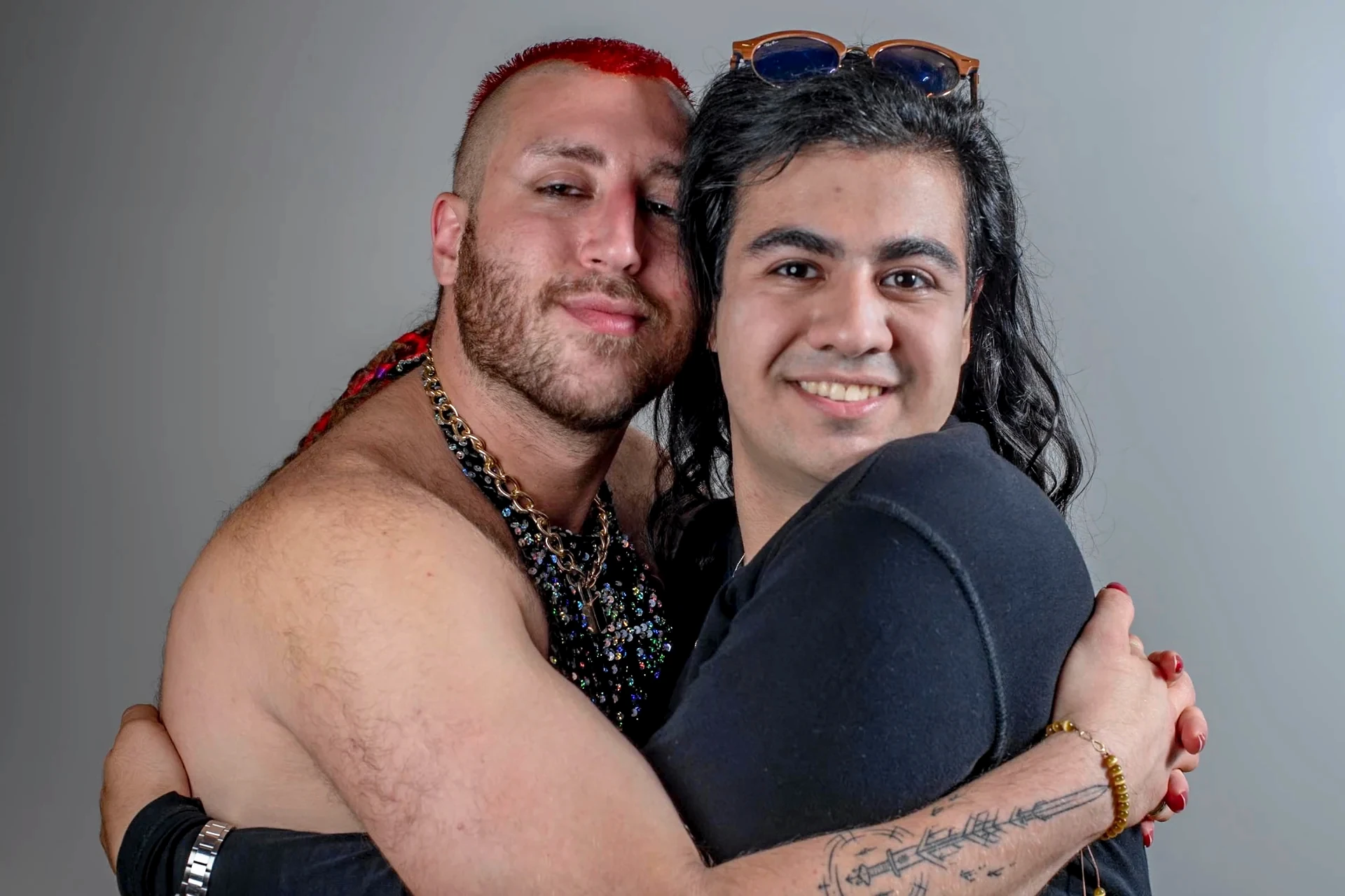 An embrace in the room, with red hair catching the light.